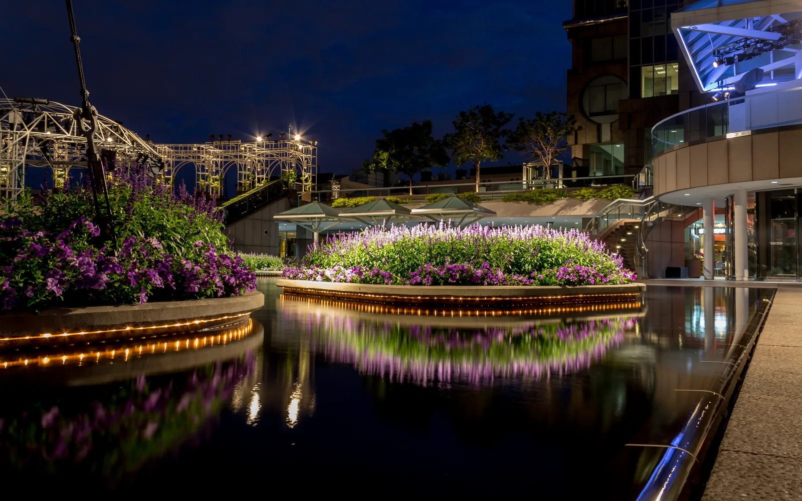 Downtown civic plaza with fountain and architecture illuminated at twilight