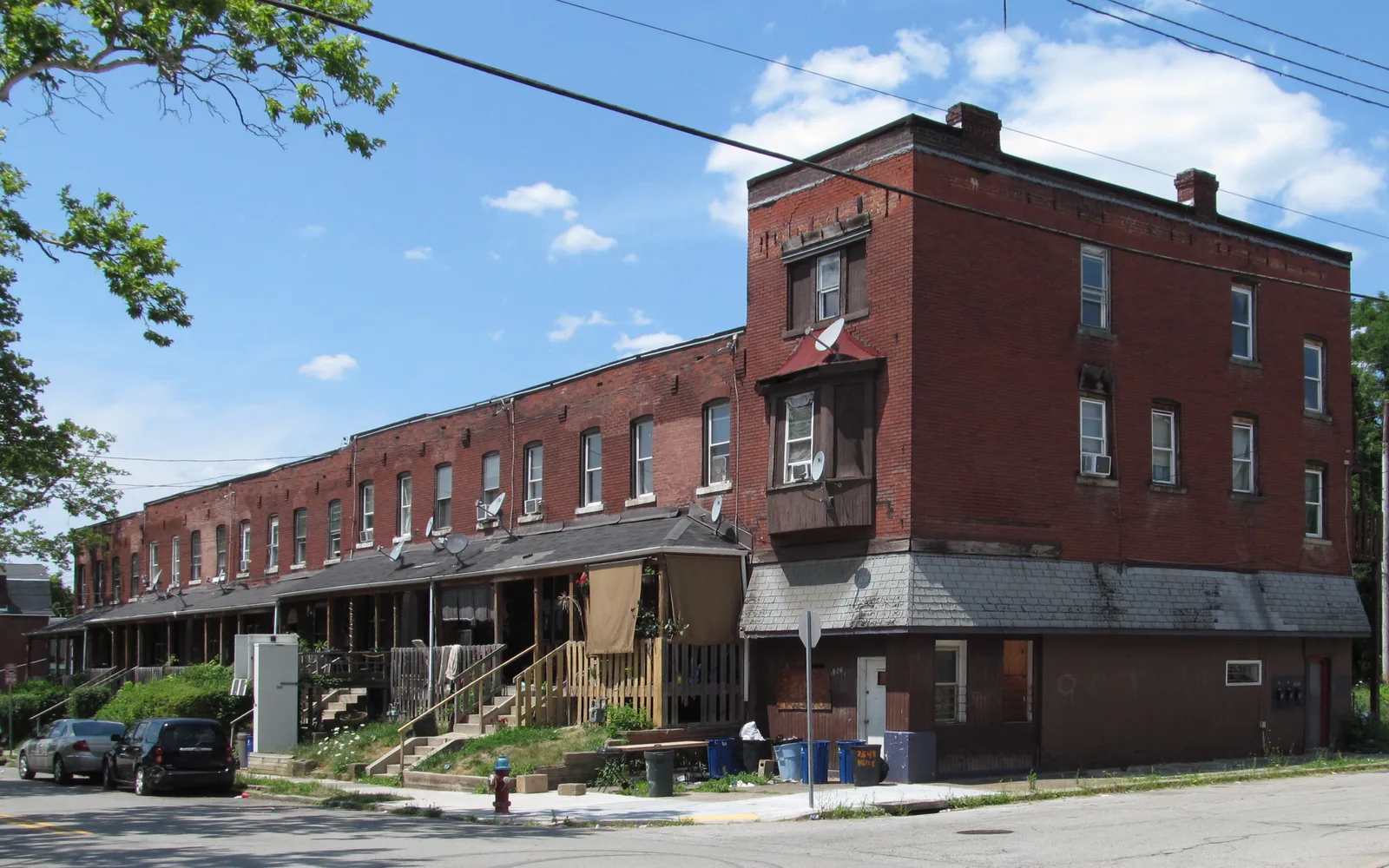 Row of residential homes with varied architectural styles and mature trees